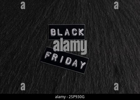 Black Friday sale tag on black stone background. Black Friday concept Stock Photo