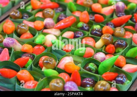 close-up shot of Luk Chup, traditional Thai sweets made from sweetened mung bean paste, skillfully sculpted and painted to resemble miniature fruits a Stock Photo