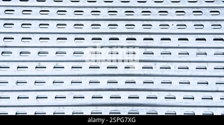 Aluminium profile manufacturing. Structural metal aluminium shapes. Aluminium profiles texture for constructions. Aluminium constructions factory back Stock Photo