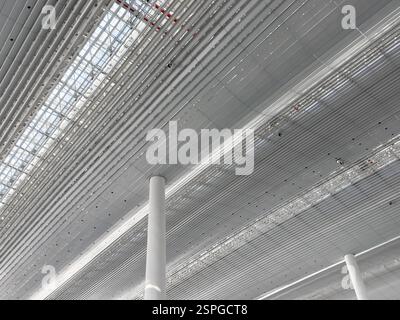 Lights and ventilation system in long line on ceiling of the industrial building. Exhibition Hall. Ceiling factory construction. Stock Photo