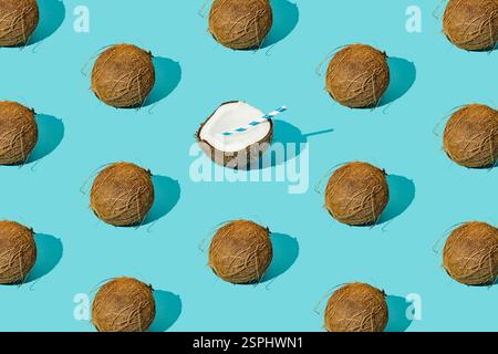 Fruit pattern made of coconuts on light pastel blue background. Minimal tropical beach concept. Nature summer composition. Trendy summer party idea. Stock Photo