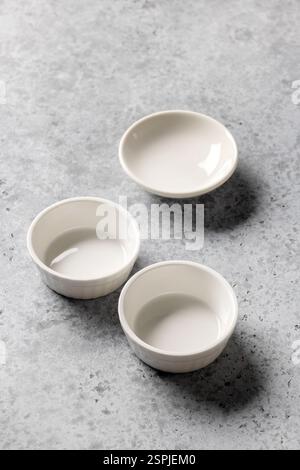 empty clean bowls on grey kitchen table background Stock Photo