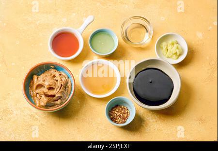 various salad dressing ingredients on yellow table background Stock Photo
