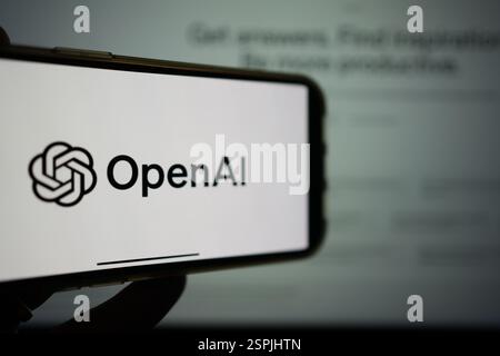 Roosendaal, The Netherlands - February 10, 2025: A mobile phone displaying the logo of OpenAI, with the logo of ChatGPT in the background. Stock Photo
