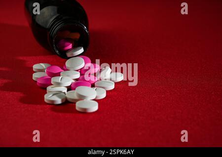 Close up of red pills scattered on the table Stock Photo - Alamy