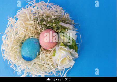 Aerial photo of hand decorated eggs and flowers. Pastel shades Stock Photo