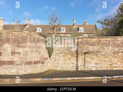 Fossil stone wall with a bastion made of local limestone, in the market town of Uppingham, Rutland, England. Stock Photo