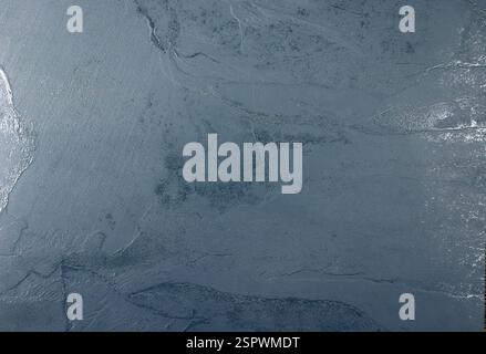 Blue background throughout the frame with a rough surface. Stock Photo