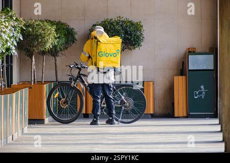 Glovo employee taking the order from McDonalds Stock Photo