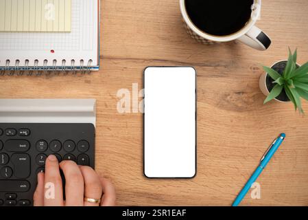 Smartphone mockup, empty, white screen on desk, top view Stock Photo