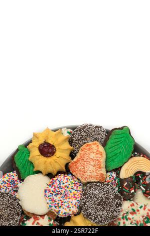 Christmas cookies assorted shortbread partial plate snacks white background copy space. Stock Photo