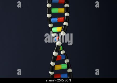 DNA structure model on dark background, closeup Stock Photo