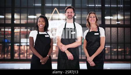Portrait of restaurant manager and happy coffee shop workers serving. Stock Photo