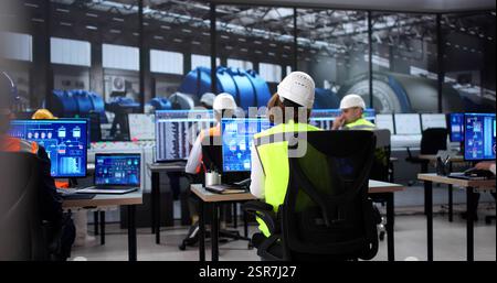 Engineer Operates Scada Software on Modern Desktop at Power Plant Stock Photo