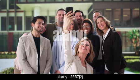 Multicultural Business Team Celebrating Success with Group Selfie at Event Stock Photo