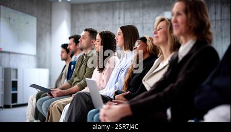 Employees waiting for job interviews in diverse office setting, businesspeople. Stock Photo