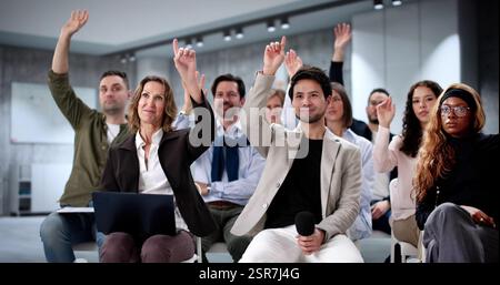 Diverse group of business professionals attending educational seminar at conference center. Stock Photo