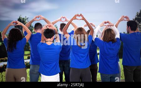 Multiracial volunteers create hearts, spreading love in local communities worldwide. Stock Photo