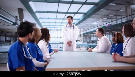 Multiracial Hospital Team Collaborating during Professional Training Presentation in Medical Field Stock Photo