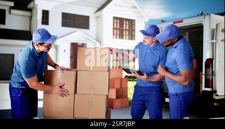Busy Mover Unloading Van, Carrying Boxes in Front of House. Stock Photo