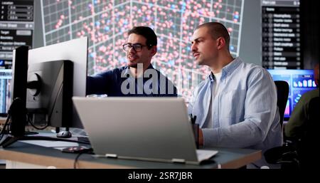 In the Cyber Data Team and Monitoring Center, a diverse group of professionals work together to ensure the security of computer technology and data. Stock Photo