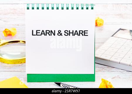 This setup illustrates the importance of learning and sharing knowledge in business and finance, featuring a notebook and office supplies. Stock Photo