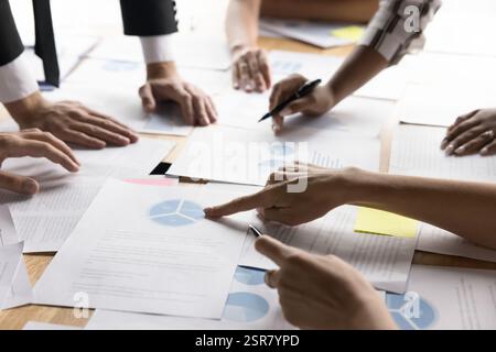businesspeople review graphs and pie charts, focused on data analysis Stock Photo