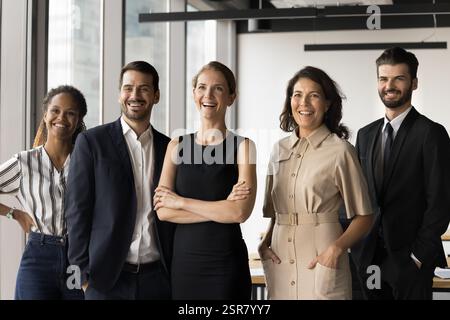 Diverse corporate members, executives, managers represent company posing at workplace Stock Photo