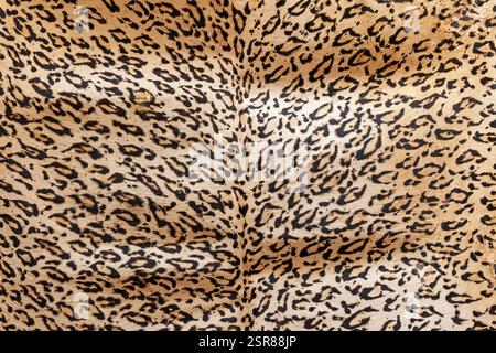 Leopard skin background.  Tanned leather stretched on the wall. Horizontally. Stock Photo