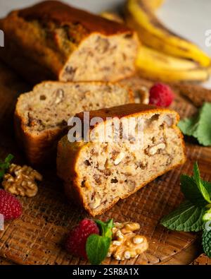 Delicious piece of banana and walnut cake on a rustic wooden base. Stock Photo