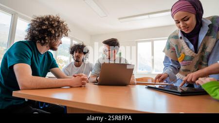 A group of diverse college students studying together or a business team working together on a project plan in the office workplace. Stock Photo
