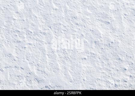 Close-up of fresh and bright snowy land in the winter on a sunny day, viewed from above. Abstract full frame background with copy space. Top view. Stock Photo