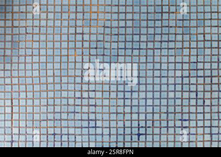 Light blue bathroom flooring tiles with weathered and dirty tile joints, viewed from above. Abstract high resolution full frame textured background. Stock Photo