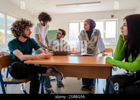 A group of diverse college students studying together or a business team working together on a project plan in the office workplace. Stock Photo