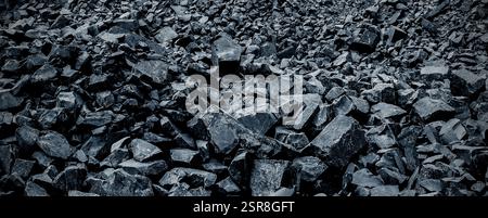 Black volcanic stone. Surface of basalt or granite close-up. Dark rough and textured rock. Dark toned background . Stock Photo