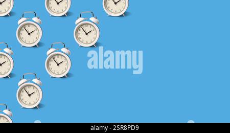 White alarm clocks on pale blue background, pattern. Banner design with space for text Stock Photo