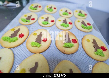 Oval biscuits with Easter decorations in the shape of bunnies and flowers on a tray, Easter baking and chocolate icing at Haselstaller Hof, Gechingen Stock Photo