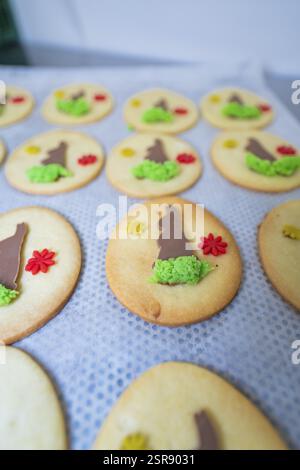Oval biscuits with chocolate bunny and flower decorations on a baking tray, Easter baking and chocolate icing at Haselstaller Hof, Gechingen, Black Fo Stock Photo