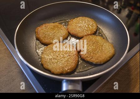 Freshly baked potato pancakes in the pan on the cooker, Bavaria, Germany, Europe Stock Photo