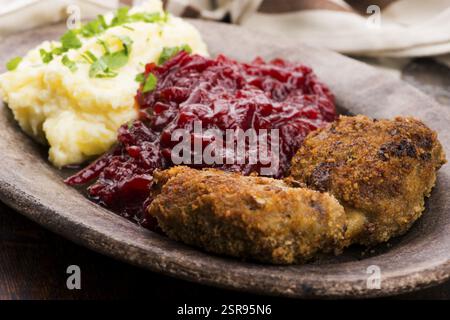 Prepared dinner on the plate. Melted meat, potatoes, beetroot Stock Photo