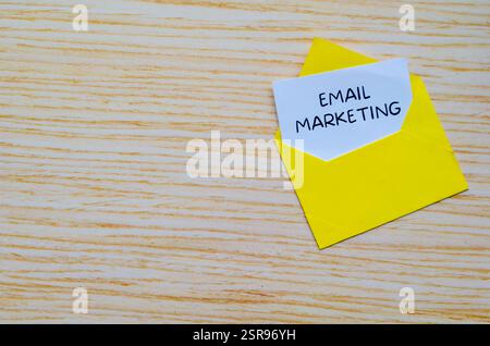 Email Marketing text on white notepad in a yellow envelope with customizable space for text Stock Photo