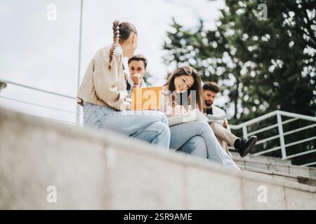 Students collaborating on outdoor steps with professor guidance Stock Photo