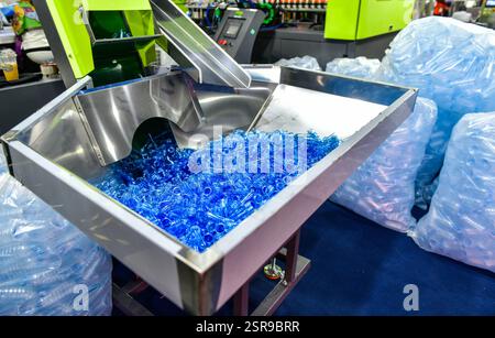 Blue Plastic bottles in production line at manufacturing PET bottle perform before bottles blowing Stock Photo