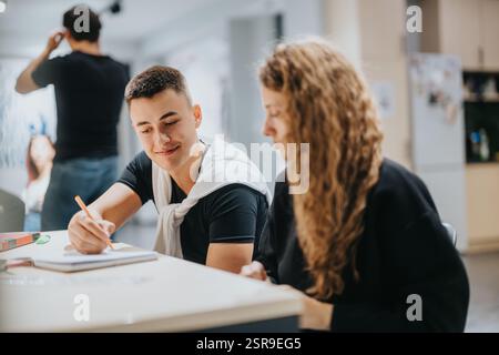 Students collaborating on group assignment in a modern classroom setting Stock Photo