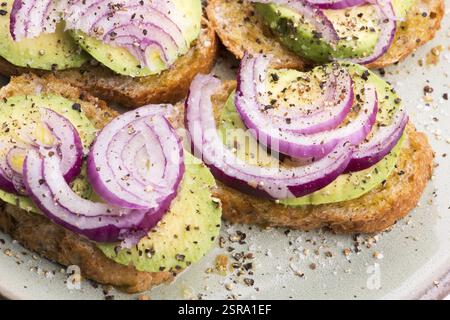 Sandwich with fresh avocado and onion on a plate Stock Photo