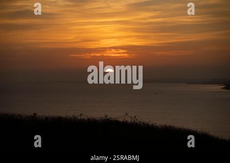 Sun setting over water. Stock Photo