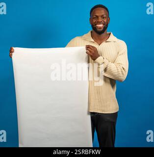 Studio shot of a smiling man holding a large blank white board Stock Photo