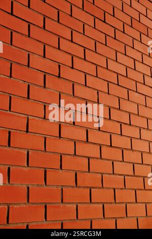 Red brick wall in perspective. Masonry brickwork background. Abstract backdrop. Stock Photo