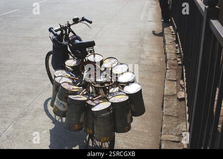 Lunchboxes tied on cycle, Bombay Mumbai, Maharashtra, India, Asia Stock Photo