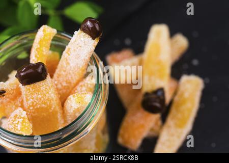 Orange slices in dark chocolate, close-up Stock Photo